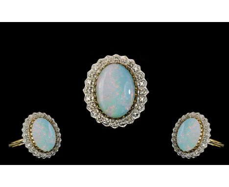 Ladies 9ct Gold - Large Opal and Diamond Set Ring. Fully Hallmarked for 9.375, The Large Oval Shaped Milky Opal with Splashes