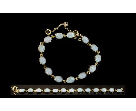 Ladies 9ct Gold Opal Set Bracelet, Set With 13 Oval Shaped Opals of Good Colour with Safety Chain. Marked 9.375, Length 6,75 