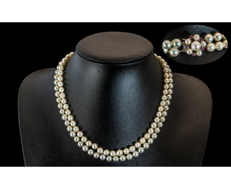 A Superb Quality Two Tone Cultured Pearl Necklace with 18ct Gold Ruby and Pearl Set Clasp. Marked 750. J.K.A Monogram. Excell