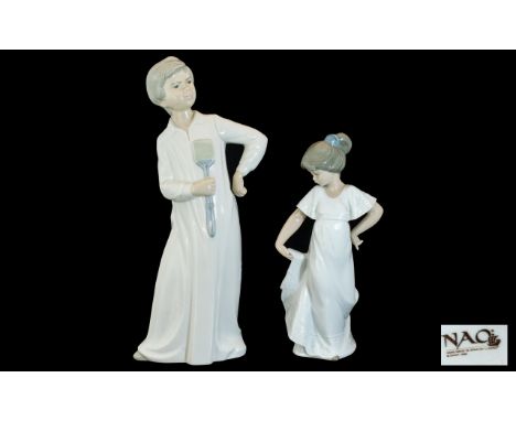 Two Nao Figures, a boy and girl, 12'' and 9'' tall.