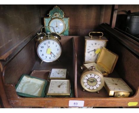 A collection of seven various clocks including Swiza, Kienzl and Marksman together with a pottery cased mantel clock 