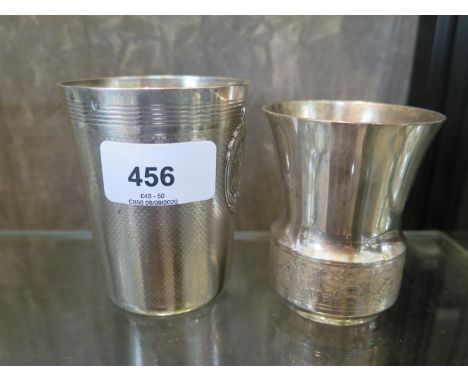 A French silver beaker with engine turned decoration, together with two plated beakers of different sizes 