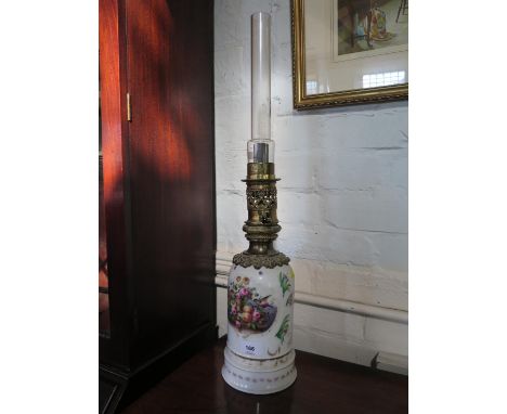 A late 19th century French porcelain oil lamp, labelled Thomas Pearce &amp; Son, painted with birds, fruit and flowers, 62 cm