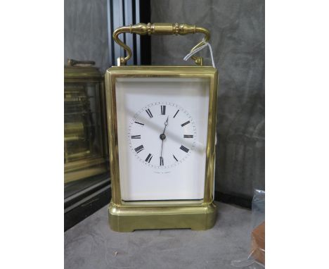 A brass carriage clock, inscribed Jules a Paris, with bevelled glass panels and inscribed enamel dial, the twin train Japy Fr