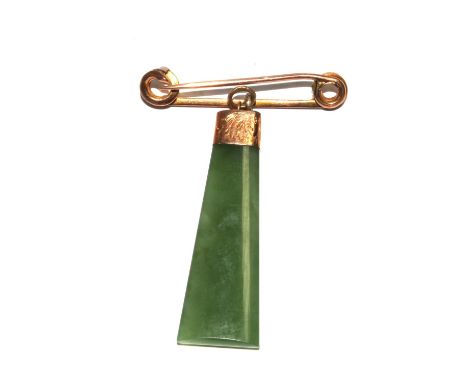 A jade pendant on gold colour pin 