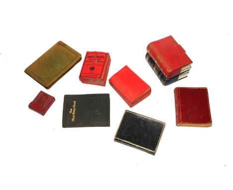 A collection of miniature books together with two packs of miniature playing cards 