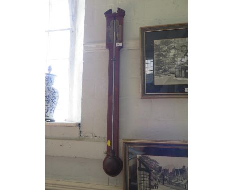 A George II style mahogany stick barometer, with broken pediment over a brass dial and globular reservoir, 96 cm high 