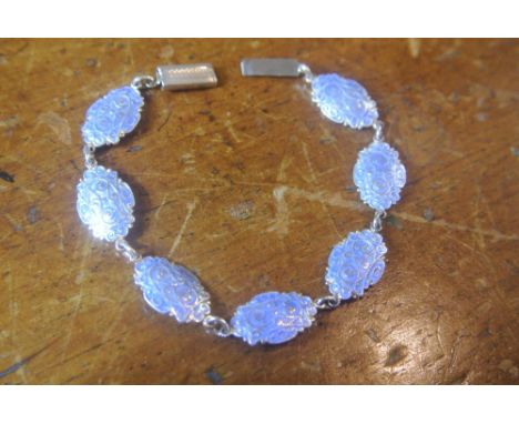 SILVER & ENAMEL BLUE OVAL DISC BRACELET: A silver chain bracelet consisting of oval silver pieces with enamel front and scrol
