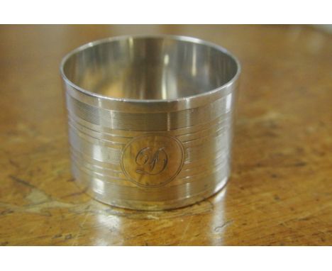 SILVER NAPKIN RING WITH MONOGRAM: A solid silver single napkin ring with engine turned decoration and monogramed with the ini