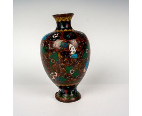 A small footed vase in a dark red and copper enamel ground. Decorated with flowers and butterflies, and dark metal wiring acc