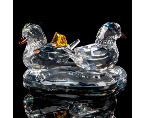 A set of three clear crystal figures, two ducks and a lake for them to be placed upon. Both ducks have clear bodies and brown