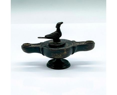 A small double spout lamp adorned with a bird finial on the lid. Dimensions: 4.5"L x 1.75"W x 2.75"HCondition: Age related we