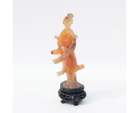 Antique carved stone of the Bodhisattva, associated with compassion, in a flowing robe. Includes carved wooden base.Figure: 2