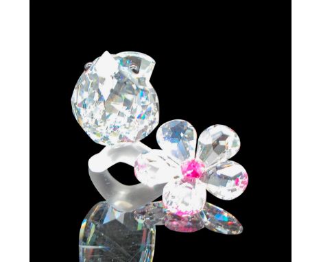 Beautiful, clear faceted body sitting on frosted branch, next to flower with raspberry colored crystal center. Swarovski back