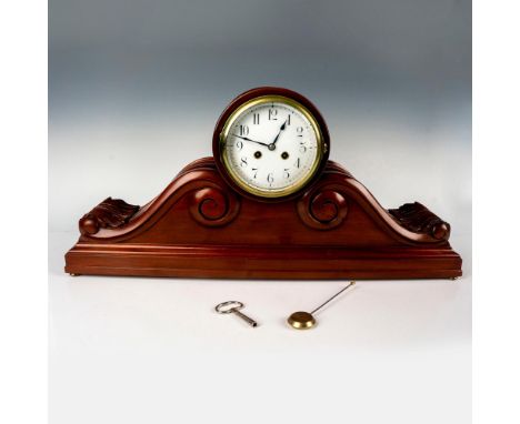 Exceptional, mansion style oversized wooden clock with chime. Gold-tone metal accents. Includes original pendulum and key. Di