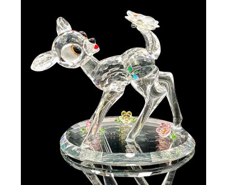 This adorable figurine, embellished with colored crystals, depicts the loveable Bambi staring at a butterfly on his tail. Thi