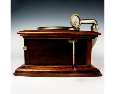 A charming early hornless Phonograph, elegantly encased in a gorgeous mahogany cabinet, complete with a crank and extra needl