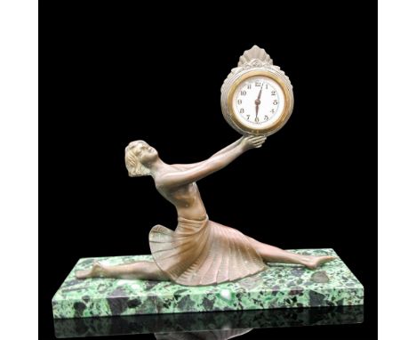 Woman figural with extended arms holding clock on green marble base. Clocked marked Germany - Quartz. Dimensions: 12"L x 4"W 