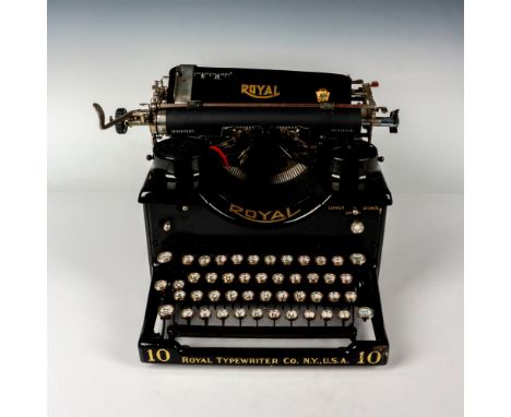 An antique desk typewriter with open side panels to display the mechanics. Includes manual and parts. Royal Typewriter Co. N.