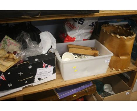 Shelf of assorted linen, books etc.