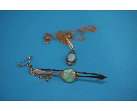 An Opal pendant on gold coloured chain and an Opal brooch