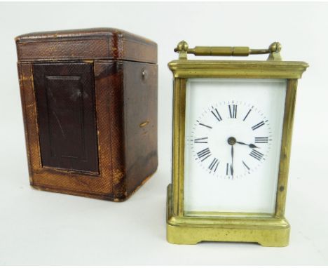 BRASS CARRIAGE CLOCK WITH ROMAN NUMERAL CHAPTER RING in velvet lined case