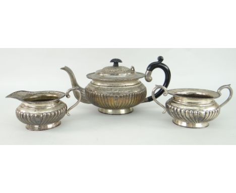 WHITE METAL ANTIQUE THREE-PIECE TEASET of oval form with fluted decoration, marked to the base 'sterling silver CK' (possibly