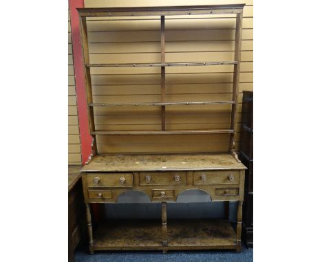 ANTIQUE LIGHT OAK WELSH DRESSER having an open base with arched frieze and five drawers, centre dummy drawer, open rack, 141c