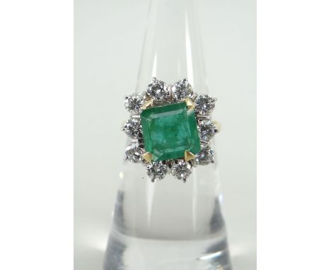 18CT YELLOW GOLD SET DIAMOND &amp; EMERALD CLUSTER RING composed of table cut centre emerald surrounded by ten round cut diam