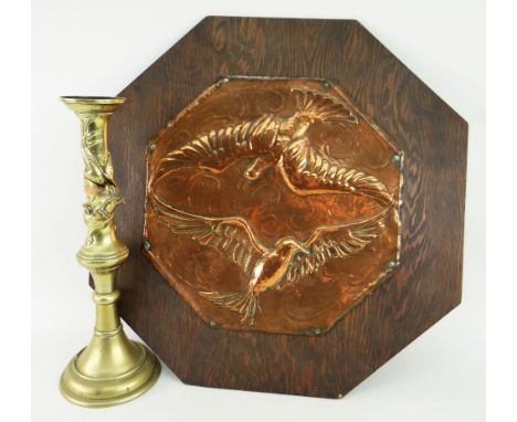 ARTS &amp; CRAFTS-STYLE COPPER PANEL OF TWO BIRDS IN FLIGHT mounted to a wooden panel together with a single brass candlestic