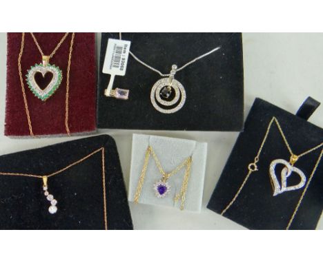 TWO 9CT YELLOW GOLD HEART SHAPED DIAMOND CHIP PENDANTS ON CHAINS, silver target design pendant on chain and two other pendant