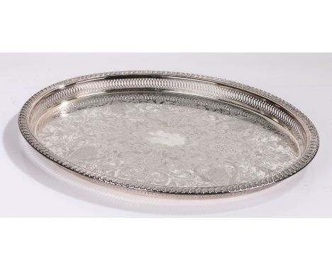 Silver plated oval tray with gadrooned and pierced border, the central field with acanthus leaf, foliate, scale and scroll de