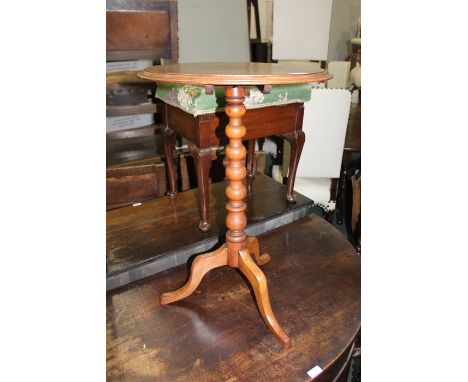 Mahogany wine table, the circular tilt top raised on a bobbin turned stem and tripod legs, 44cm diameter