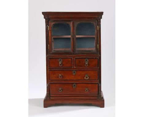 George III miniature mahogany cabinet, the plinth cornice above a pair of glazed doors, the lower section with two short and 