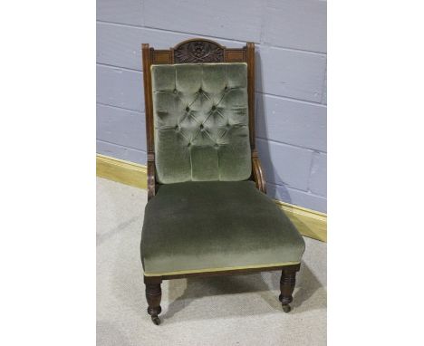 Edwardian parlour chair, the mahogany frame with carved decorations to the top, above a button back seat upholstered in green