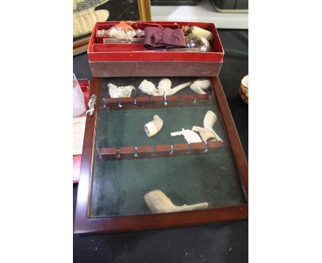 Collection of clay pipes, to include figural examples, housed in three glazed display cabinets, Sir Hiram Maxim's pipe of pea