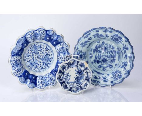 Two early Delftware lobed dishesand a miniature dish or stand, all circa 1680-1700, painted in blue with Chinese designs, the