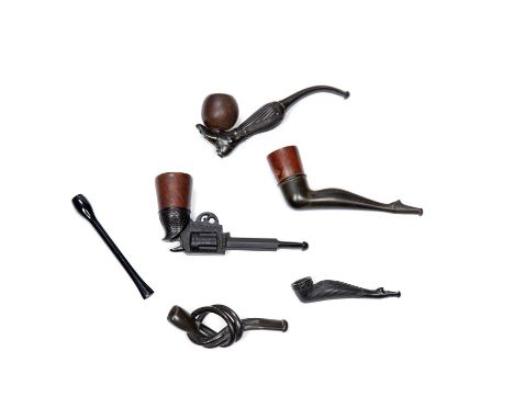 Collection of vulcanite smoking pipesto include one in the form of a footballers leg kicking a football, another similar pipe