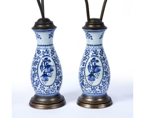 Pair of Delft pottery lamp baseswith brass mounts, 53cm (excluding shades)Condition report: Light wear and marks consistent w