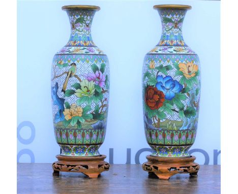 Pair of white cloisonne enamel vases20th Century, with floral decoration on open fret carved wooden stands, 26cm high excludi