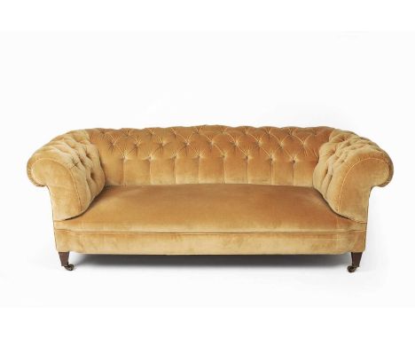 Large button upholstered Chesterfieldon mahogany supports with brass castors, 198cm wide, 96cm deep, 69cm highOn line only - 