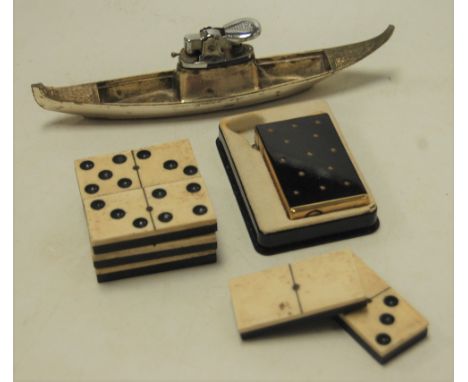 A Japanese novelty table lighter in the form of a junk, together with various bone and ebony dominoes, one other boxed Consul