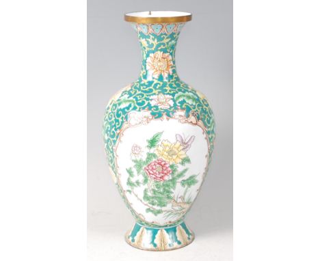 A Continental painted and enamel on metal vase, of shouldered baluster form, having opposing reserves of flowering bamboo and