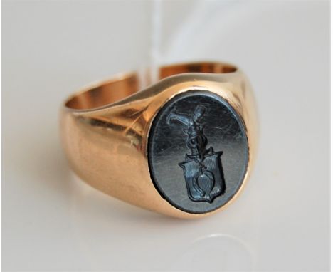 A continental gentlemans hematite signet ring, the oval intaglio hematite set to a wide tapering band, size P, (tests as appr