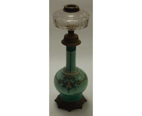 A late 19th century porcelain and brass mounted pedestal oil lamp (lacking shade), h.47cm