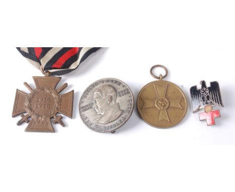 A German Cross of Honour with swords, together with a German War Merit medal, a Hitler's Dank 1933-34 Winter Aid badge and a 