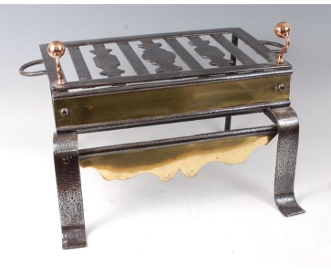 A George III steel footman, having twin brass finial surmounts, two tiers, and on scroll forelegs, w.63cm, h.40cm