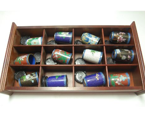 A display of twelve modern cloisonné enamel beakers on stands