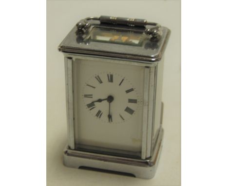 A mid 20th century chrome cased carriage clock having an enamel dial with Roman numerals and visible platform lever escapemen