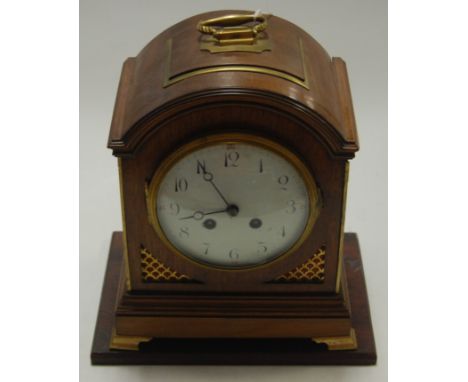 A Georgian style mahogany dome topped mantel clock, having convex white enamel dial, French eight day brass cylinder movement